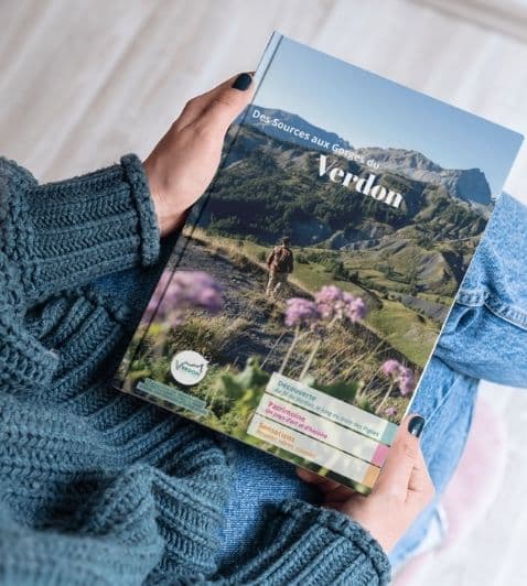 image d'une femme tenant le magazine sources d'envies de l'OTI Verdon Tourisme